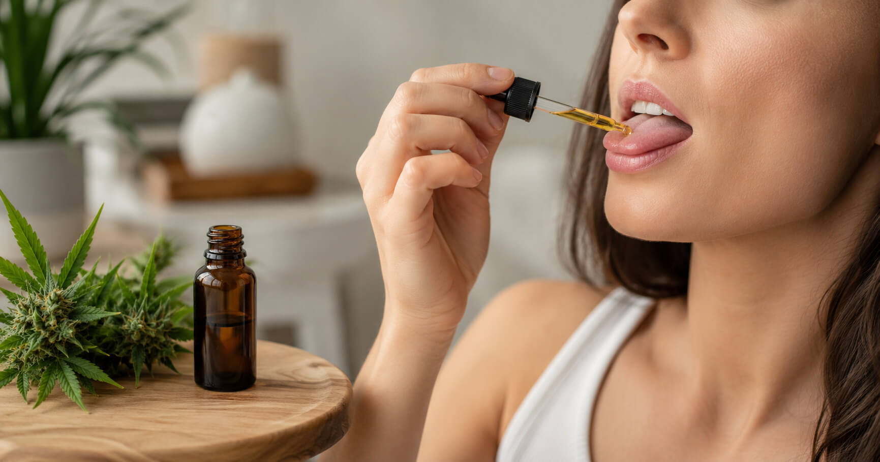 Man placing a sublingual cannabis strip on his tongue at CREAM cannabis dispensary in Jersey City.